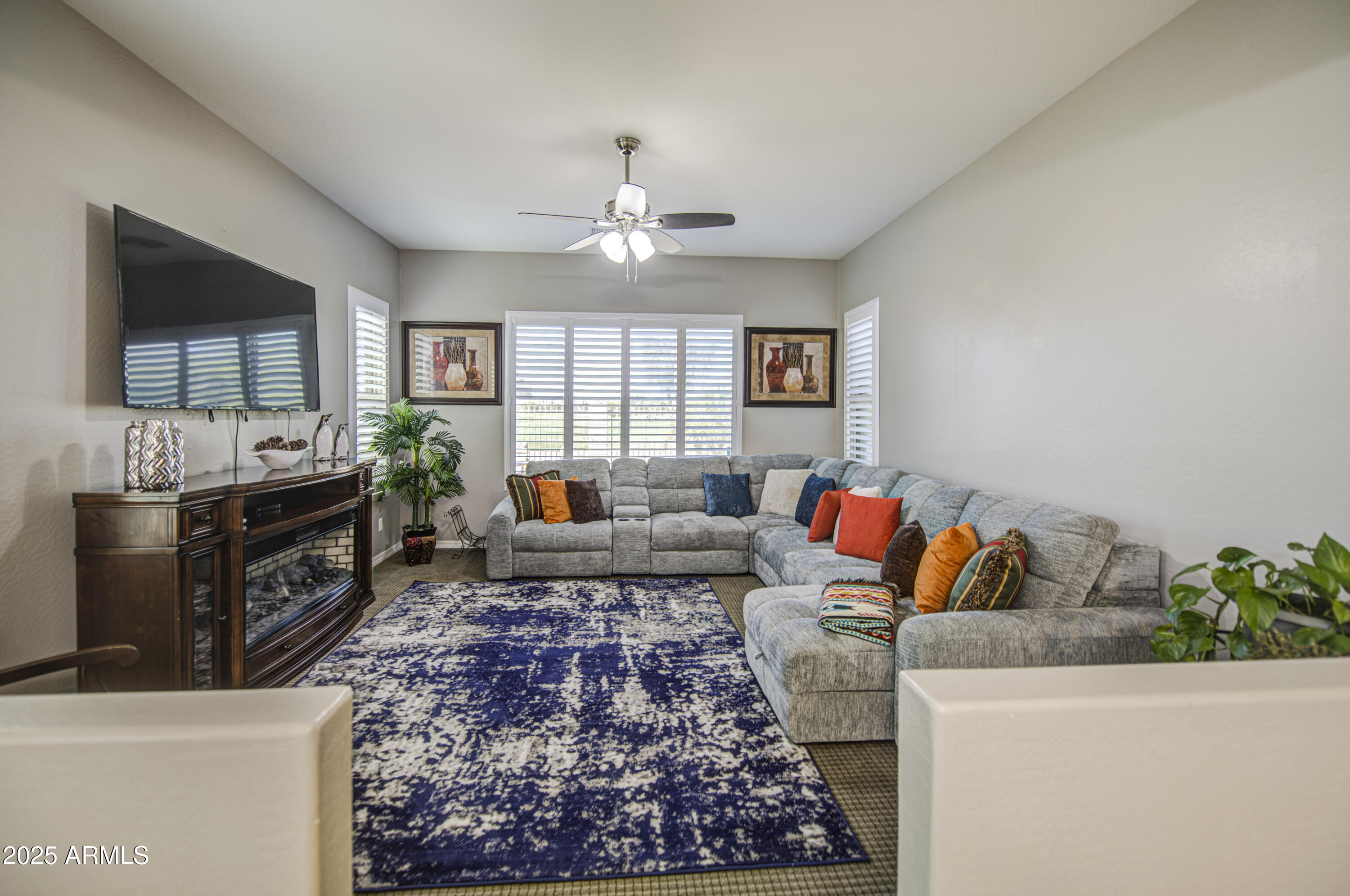 14304 West Coronado Road Goodyear, AZ 85395 - Photo 24 of 66 a living room with furniture and a flat screen tv