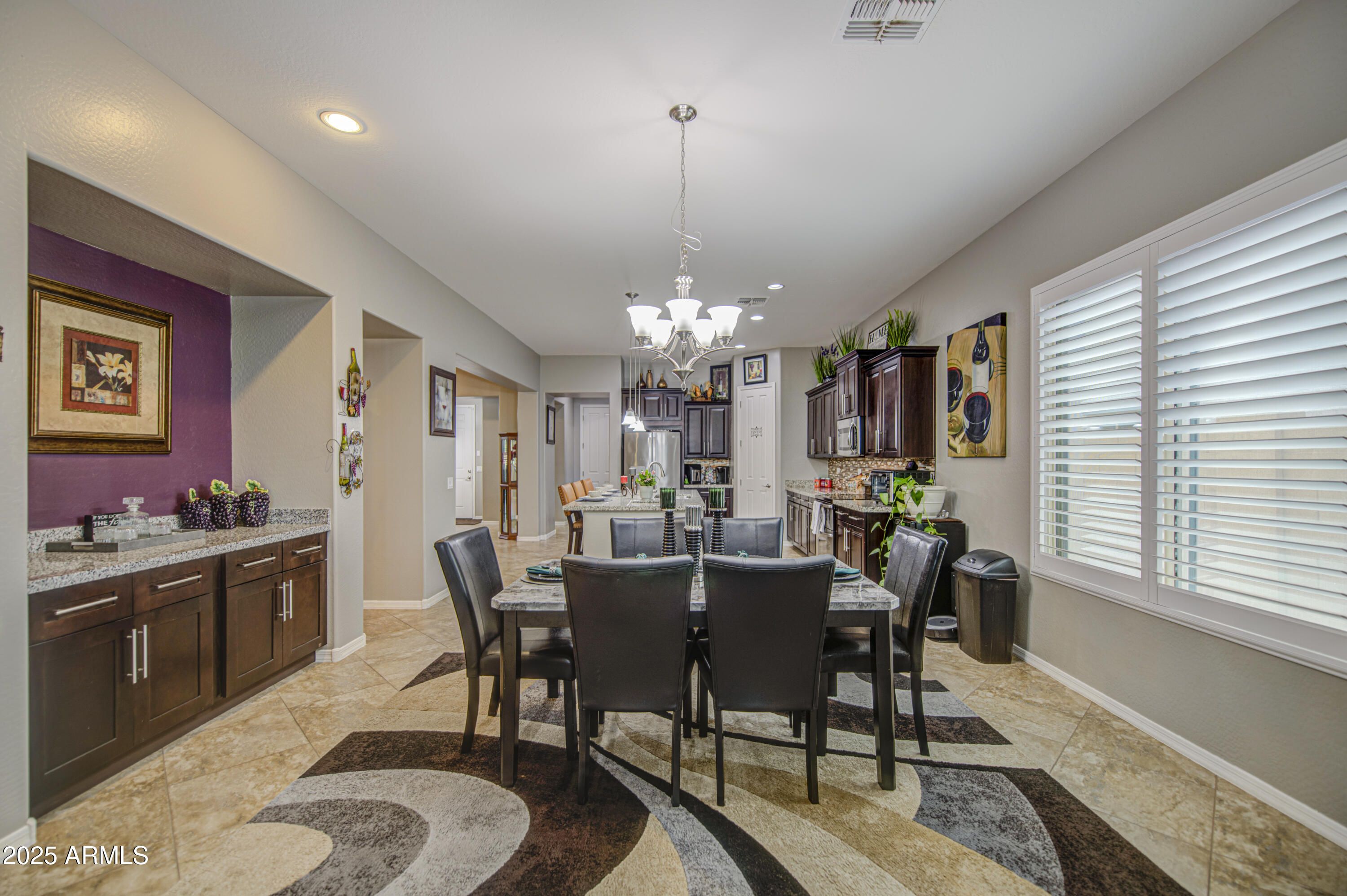 14304 West Coronado Road Goodyear, AZ 85395 - Photo 30 of 66 a view of a dining room with furniture window and wooden floor