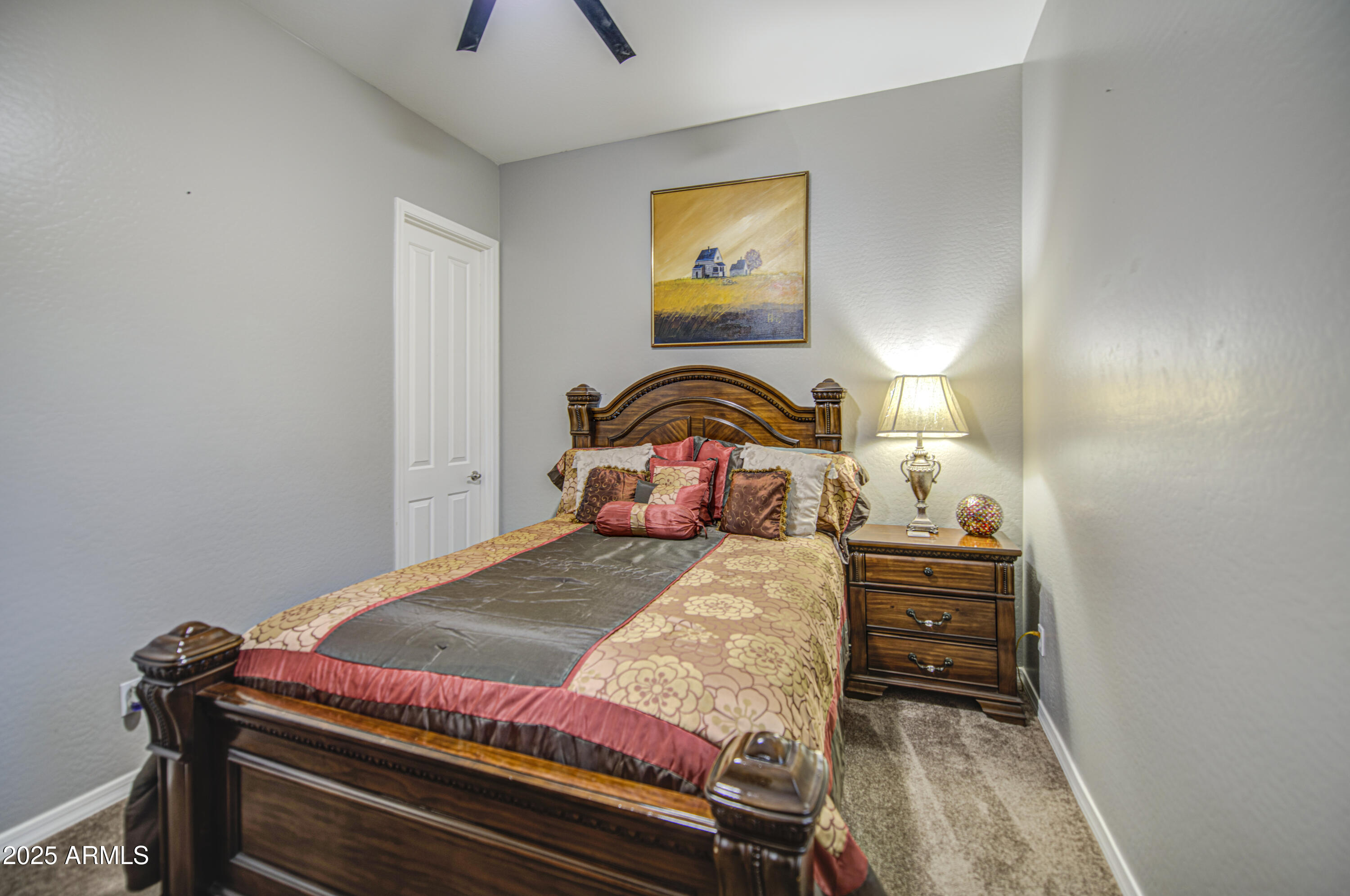 14304 West Coronado Road Goodyear, AZ 85395 - Photo 33 of 66 a bedroom with a bed and a painting on the wall
