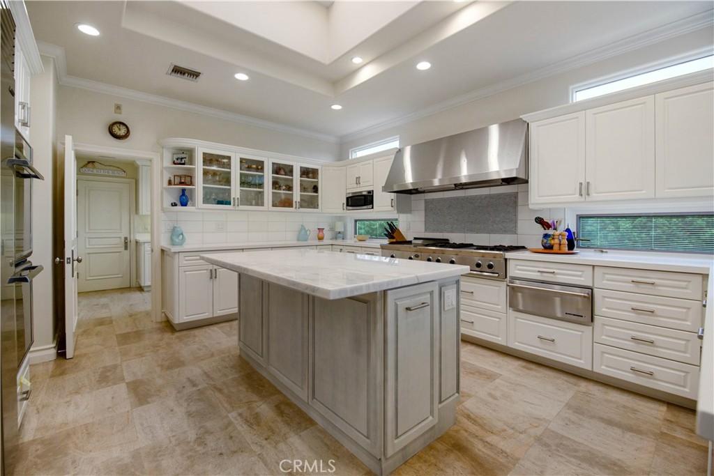 27 Marbella Dana Point, CA 92629 - Photo 11 of 66 a kitchen with granite countertop a sink stove and cabinets
