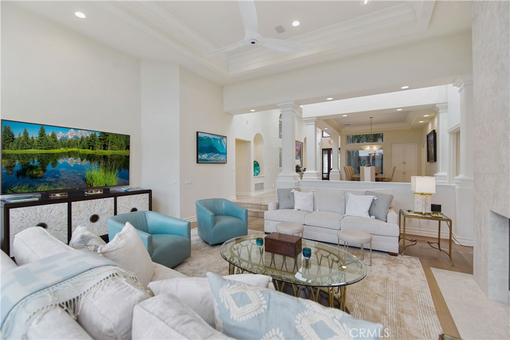 27 Marbella Dana Point, CA 92629 - Photo 17 of 66 a living room with furniture a flat screen tv and a floor to ceiling window