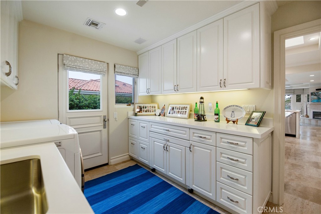 27 Marbella Dana Point, CA 92629 - Photo 28 of 66 a kitchen with white cabinets and white appliances
