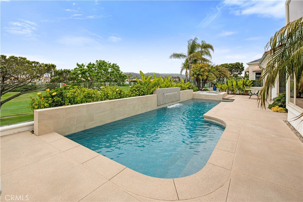 27 Marbella Dana Point, CA 92629 - Photo 51 of 66 a view of a swimming pool with an outdoor space and seating area