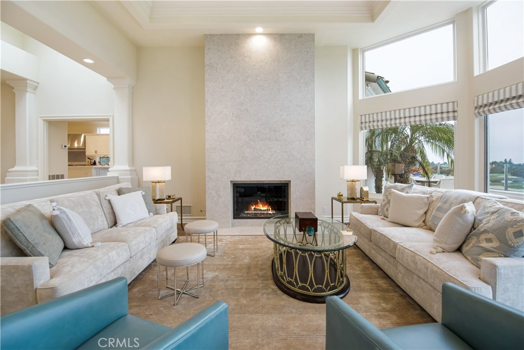 27 Marbella Dana Point, CA 92629 - Photo 54 of 66 a living room with furniture a large window and a fireplace