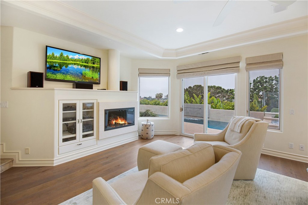 27 Marbella Dana Point, CA 92629 - Photo 55 of 66 a living room with furniture a flat screen tv and a fireplace