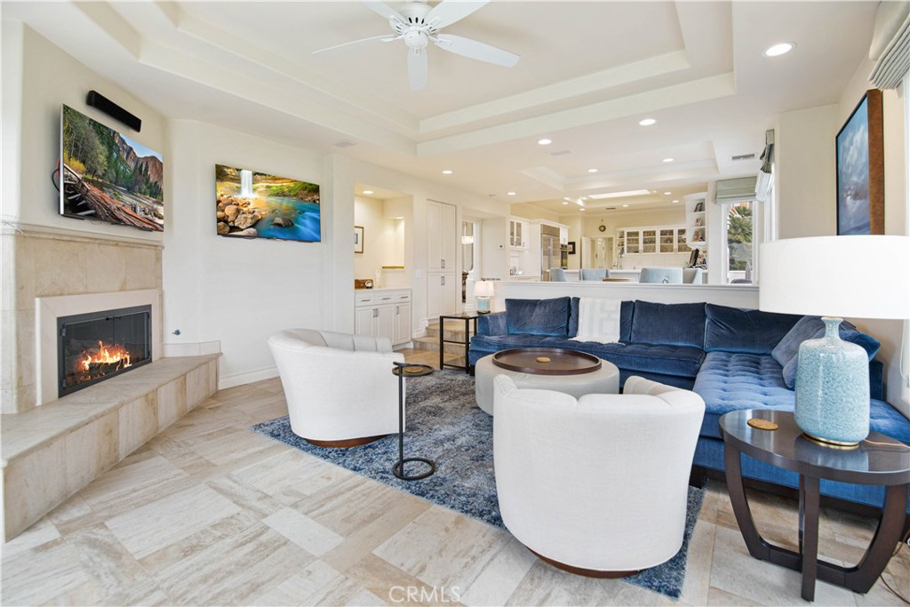 27 Marbella Dana Point, CA 92629 - Photo 61 of 66 a living room with furniture a flat screen tv and a fireplace