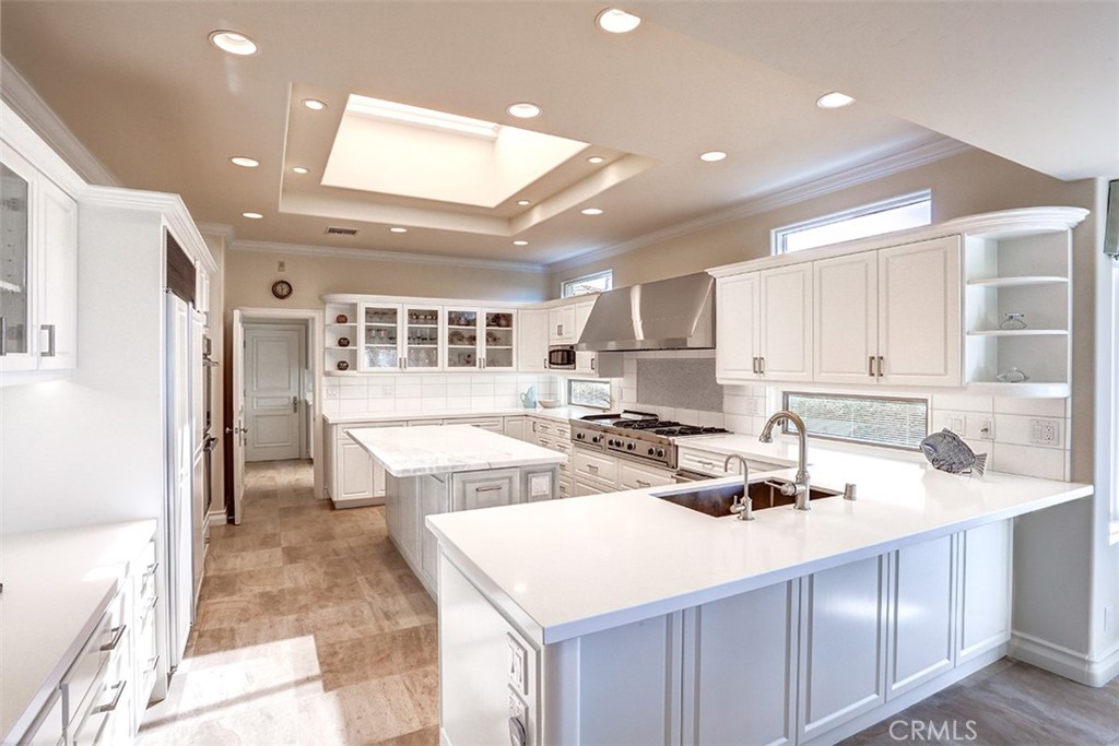 27 Marbella Dana Point, CA 92629 - Photo 7 of 66 a kitchen that has a sink a stove and chairs