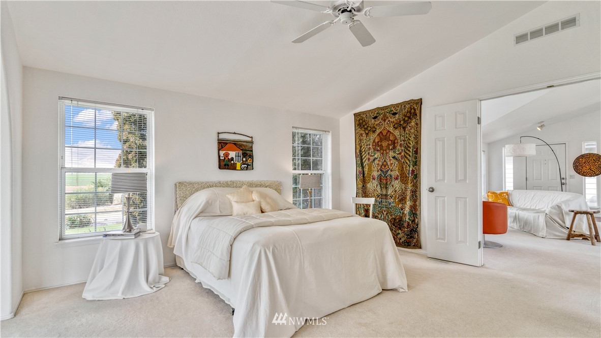 175118 West Byron Road Prosser, WA 99350 - Photo 14 of 36 a bedroom with a large bed and a chandelier
