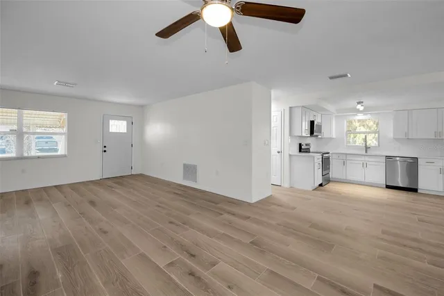 a kitchen with a refrigerator a sink and a stove top oven