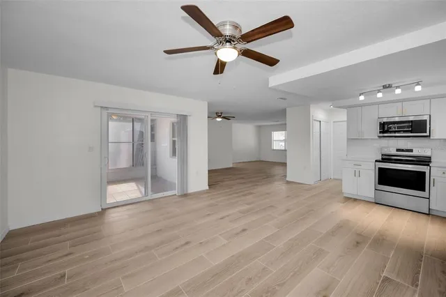 a view of a kitchen with a microwave and a refrigerator