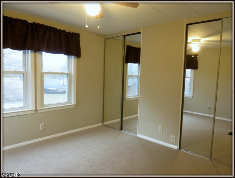 46 Orchard Street, Unit 2 Newton, NJ 07860 - Photo 17 of 18 a view of hallway with a large window and chandelier fan