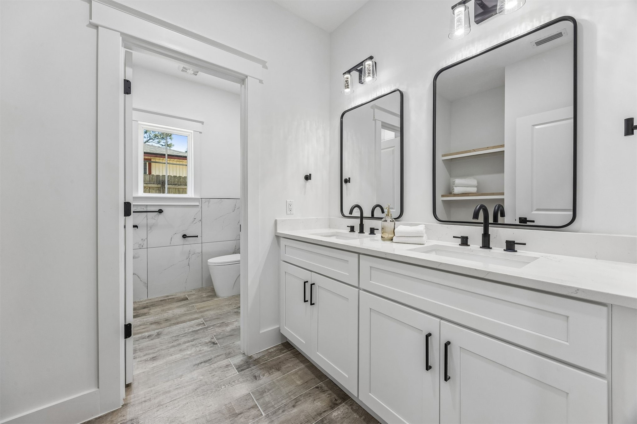 95121 North Ellis Landing Road Fernandina Beach, FL 32034 - Photo 26 of 37 a bathroom with a double vanity sink mirror and toilet