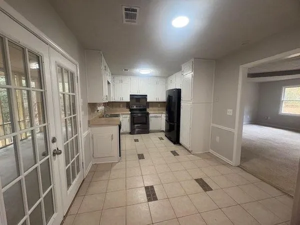 a kitchen with stainless steel appliances a refrigerator and a stove top oven