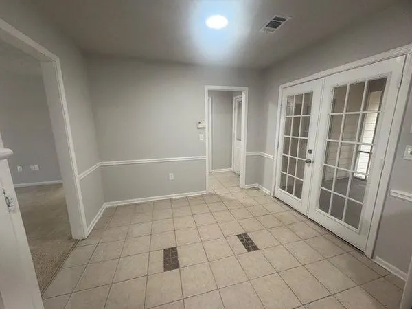 an empty room with white walls and door