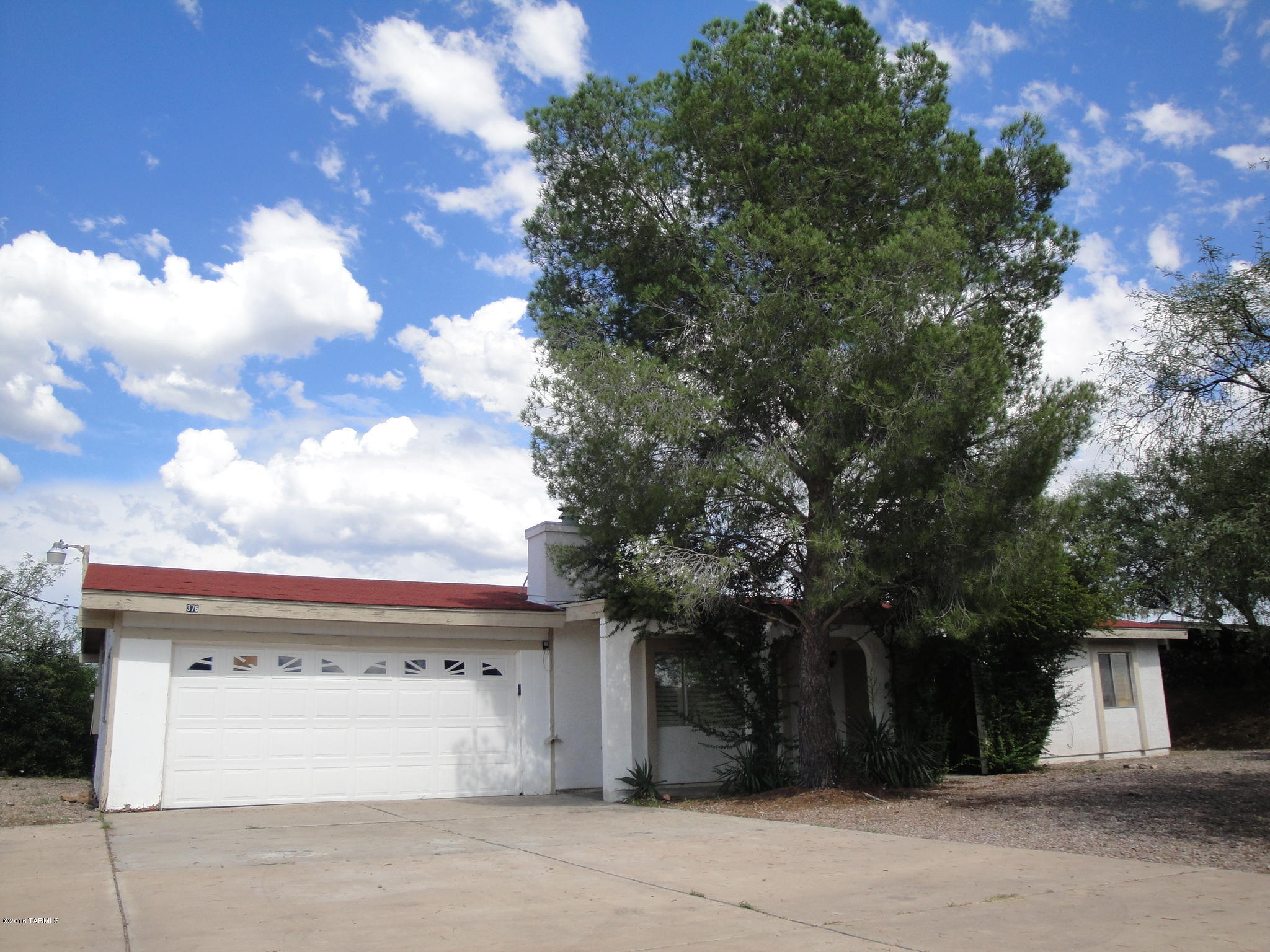 376 Via Papagayo Rio Rico, AZ 85648 - Photo 2 of 10 a front view of a house with a yard and garage
