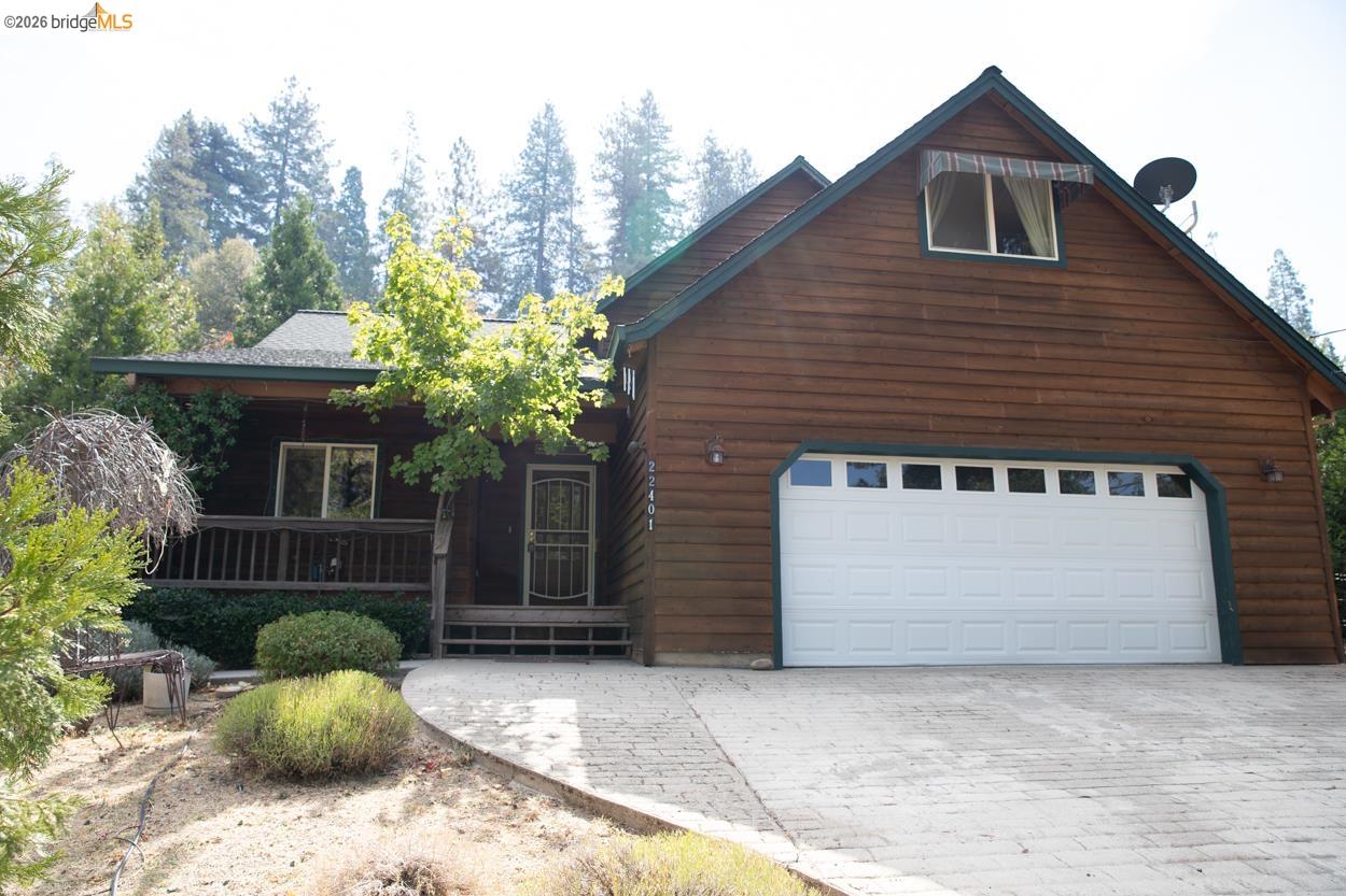 Log-style siding exterior with a dark green roof