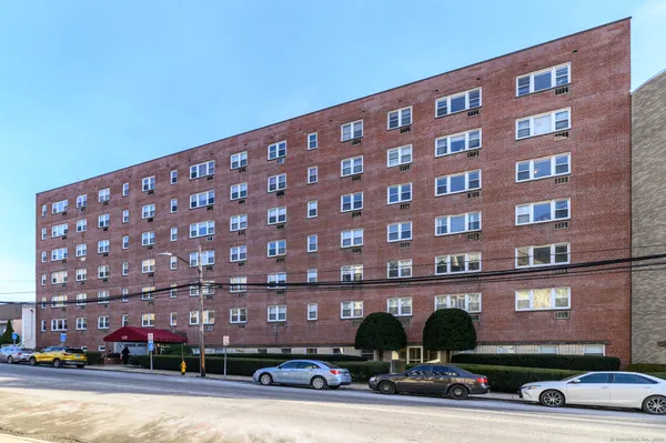 a view of a building and a cars parked in front of it