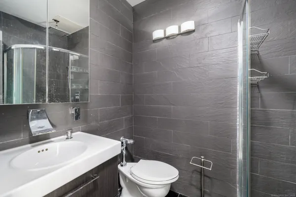 a bathroom with a sink toilet and shower