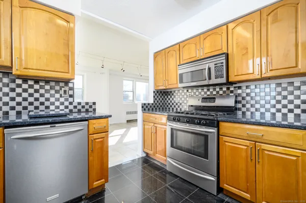 a kitchen with stainless steel appliances granite countertop cabinets and a sink