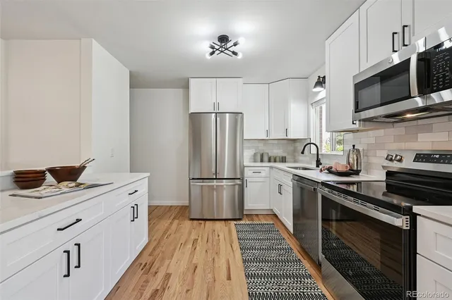 a kitchen with a sink stove and refrigerator