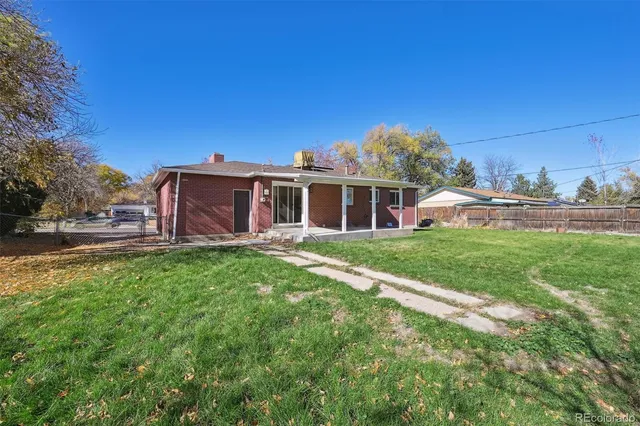 a view of a house with backyard porch and sitting area