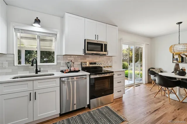 a kitchen with a stove a sink and a microwave