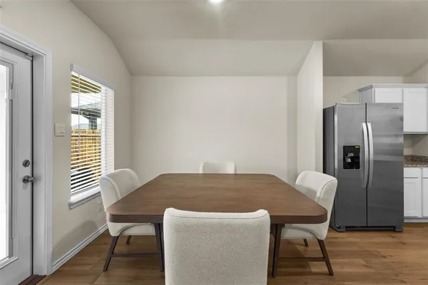 a view of a dining room with furniture and wooden floor