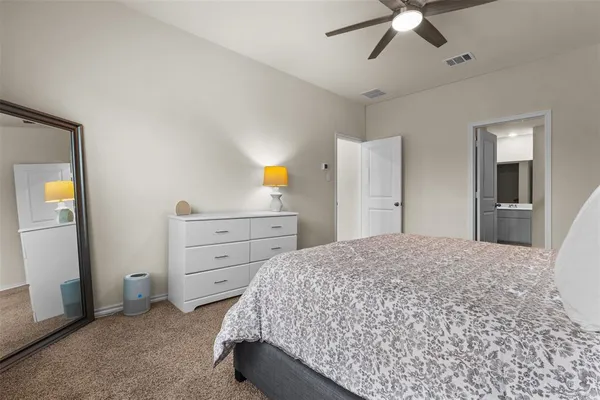 a bedroom with a bed and cabinets