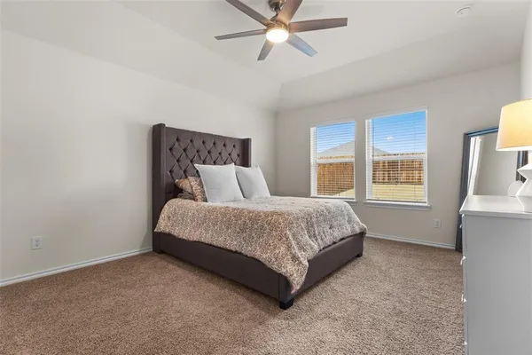 a spacious bedroom with a bed and window