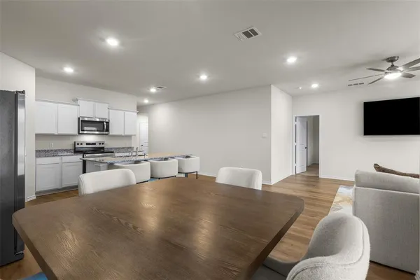 a kitchen with stainless steel appliances a refrigerator and a stove top oven