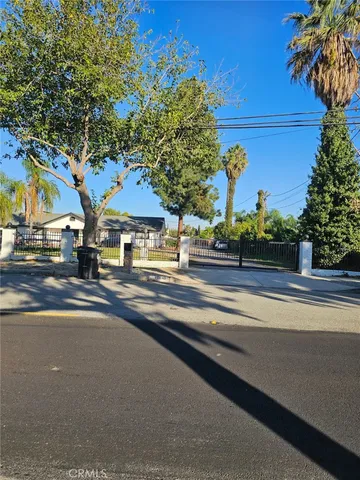 a view of street with large trees