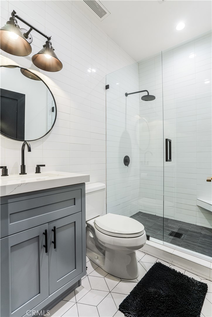 14614 Round Valley Drive Sherman Oaks, CA 91403 - Photo 11 of 35 a bathroom with a sink a toilet and shower