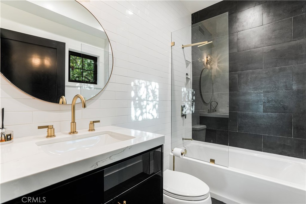 14614 Round Valley Drive Sherman Oaks, CA 91403 - Photo 13 of 35 a bathroom with a sink a toilet a mirror and bathtub