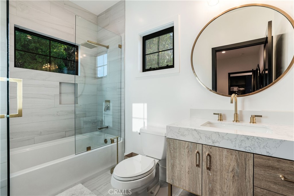 14614 Round Valley Drive Sherman Oaks, CA 91403 - Photo 21 of 35 a bathroom with a sink a toilet and shower