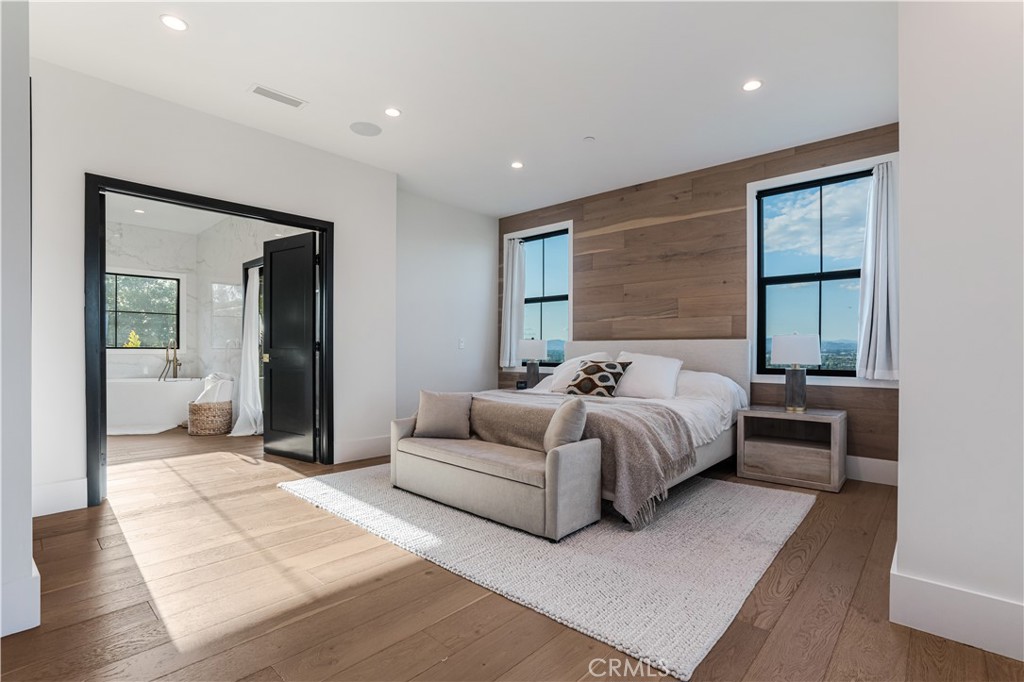 14614 Round Valley Drive Sherman Oaks, CA 91403 - Photo 22 of 35 a spacious bedroom with a large bed and a couch