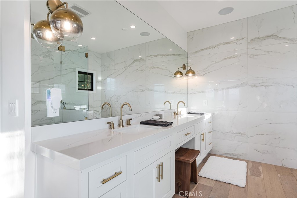 14614 Round Valley Drive Sherman Oaks, CA 91403 - Photo 27 of 35 a bathroom with a sink a large mirror and vanity