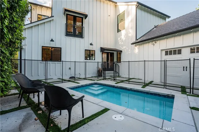 a view of a chairs and table in the back yard of the house
