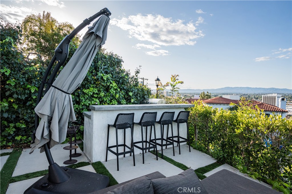 14614 Round Valley Drive Sherman Oaks, CA 91403 - Photo 33 of 35 a view of a patio with a table and chairs