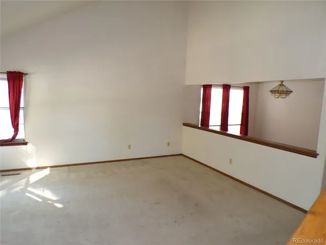 a view of empty room with a fireplace