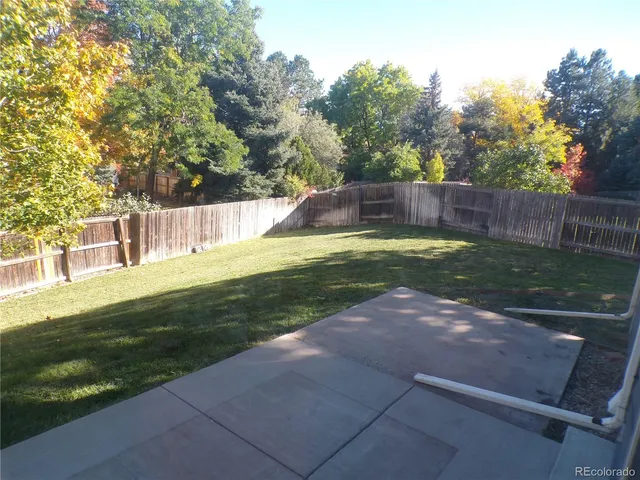 a view of house with backyard