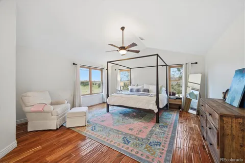 a spacious bedroom with a bed couch and a window