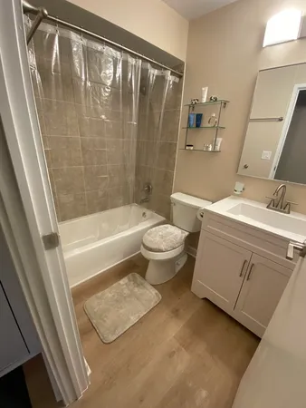 a bathroom with a sink a toilet and shower