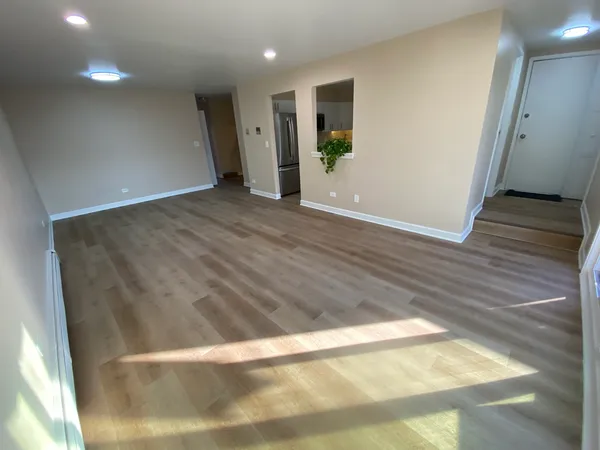 a view of hallway with wooden floor