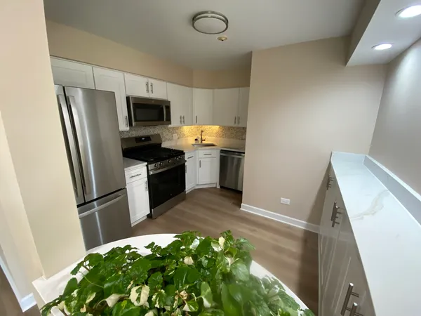 a kitchen with a refrigerator and a sink