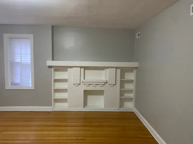 a view of a kitchen with wooden floor and electronic appliances