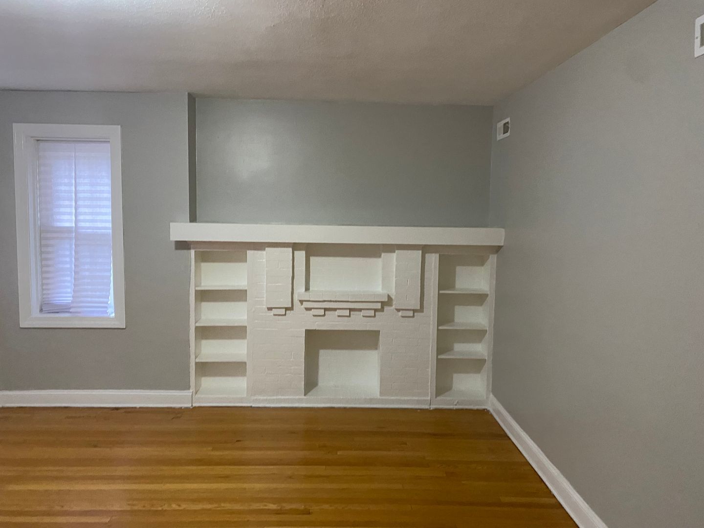a view of a kitchen with wooden floor and electronic appliances