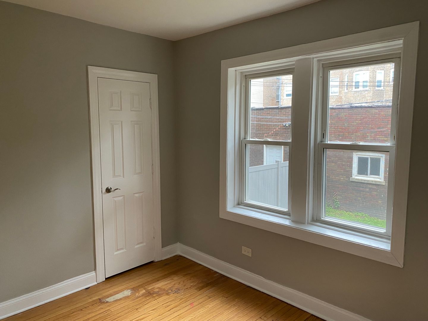 7822 South Kingston Avenue, Unit 1 Chicago, IL 60649 - Photo 11 of 15 a view of an empty room with wooden floor and a window