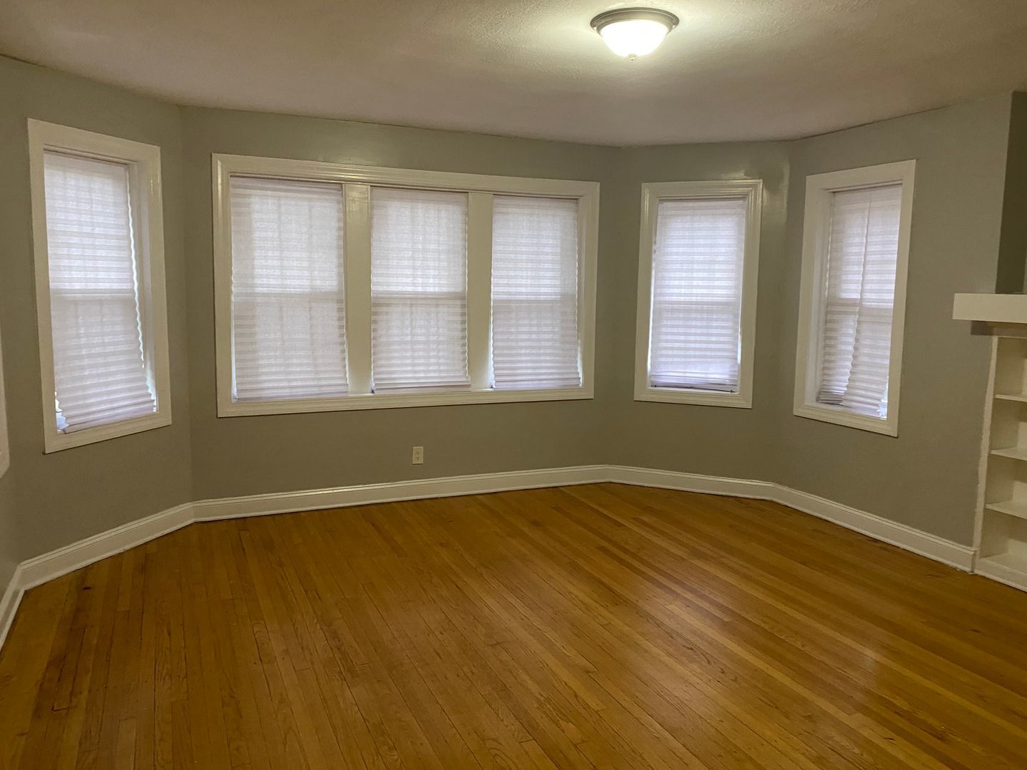 7822 South Kingston Avenue, Unit 1 Chicago, IL 60649 - Photo 15 of 15 an empty room with wooden floor and windows