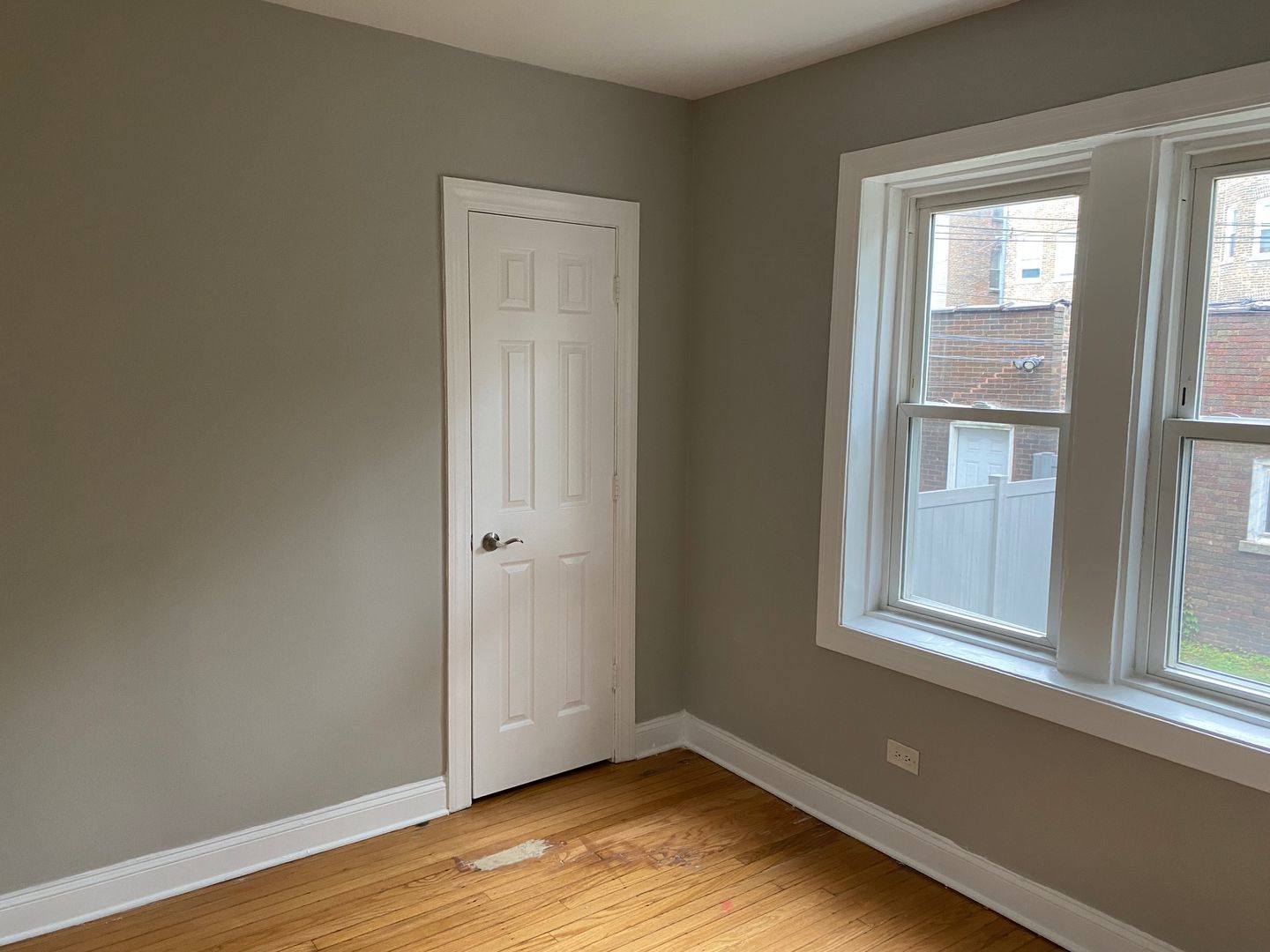 7822 South Kingston Avenue, Unit 1 Chicago, IL 60649 - Photo 9 of 15 an empty room with wooden floor and windows