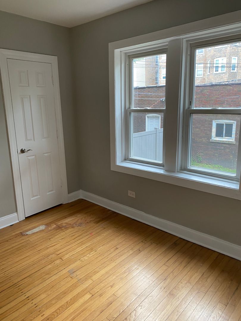 7822 South Kingston Avenue, Unit 1 Chicago, IL 60649 - Photo 10 of 15 a view of an empty room and window